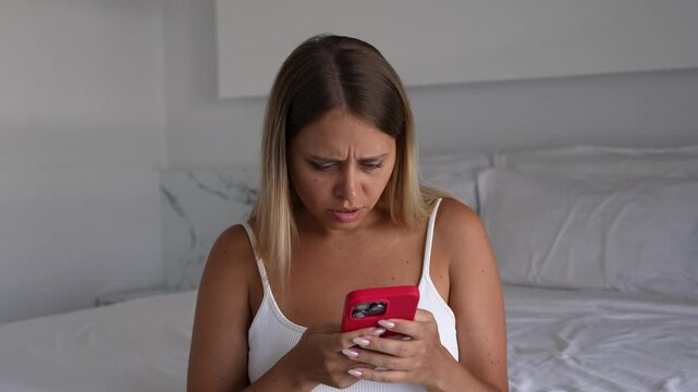 Young blonde woman touches lymph nodes on her neck, looking worried. She grabs her phone and starts searching for symptoms. A moment of anxiety, hypochondria and overthinking