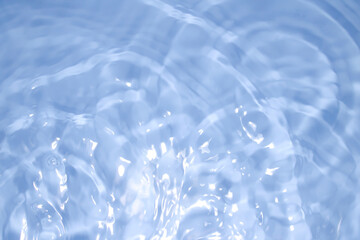 The clear blue surface of the water gradients from light to dark.