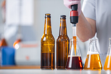 Craft beer production process with brewing equipment and bottles in factory setting