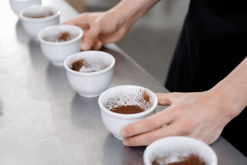 Coffee production process, preparing and inspecting ground coffee in a factory setting