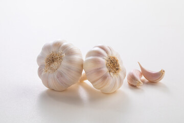 Two garlic bulb on a white background with cloves