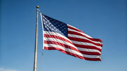 American flag waving proudly against a clear blue sky on a sunny day