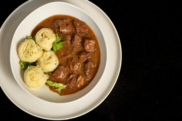 Veal with sauce prepared in a modern style, served with mashed potatoes in an elegant presentation. A delicious dinner.