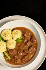 Veal with sauce prepared in a modern style, served with mashed potatoes in an elegant presentation. A delicious dinner.