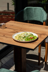 Penne pasta with spinach pesto sauce, cheese, close up