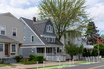 Peaceful residential street featuring spring trees and vintage homes in Brighton, Massachusetts, USA
