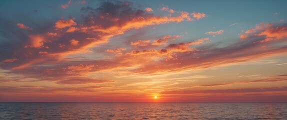 Sunset over the ocean with vibrant clouds in the sky.