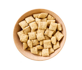 wooden bowl of tasty corn pads isolated on a white background, top view.