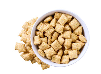 corn pillows pouring out of ceramic bowl isolated on white background. Top view.