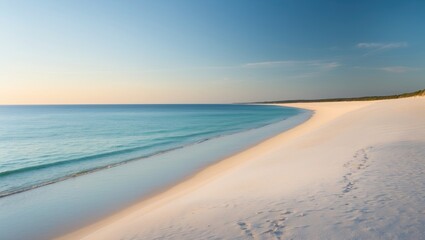 Obraz premium A peaceful beach with white sand and calm ocean waters during sunset or sunrise.