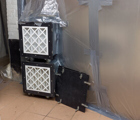 Asbestos removal with filtered air extraction