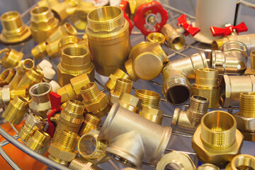 Assortment of brass water fittings on a window in a store