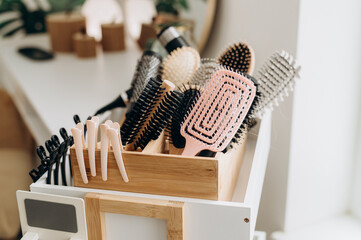 Wicker basket with scalp massage brushes arranged in spa salon head care setting