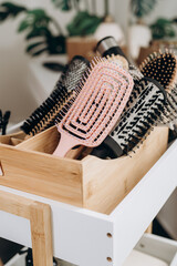 Wicker basket with scalp massage brushes arranged in spa salon head care setting
