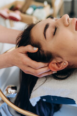 Scalp spa treatment with long dark hair on spa couch, professional hair therapy session