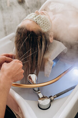 Modern scalp spa treatment in salon for hair therapy, relaxation and scalp care.