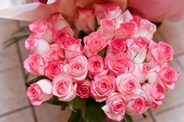 Colorful flower bouquets with roses, lilies, and ranunculus arranged on festive table.Bouquets symbolize vibrant floral decoration. Mixed flower bouquets with bright red, pink, and white tones resting