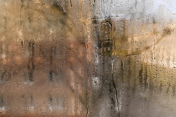 Condensation problem: water droplets form on window due to high moisture in air. Glass surface...