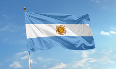 Argentinian national flag waving in the sky with sun of may symbolizing freedom and independence of...