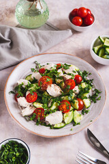 Fresh diet salad with chicken breast and vegetables on a plate on the table vertical view