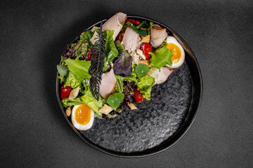 Plate of Fresh Green Salad with turkey ham, mozzarella and tomato isolated on white background
