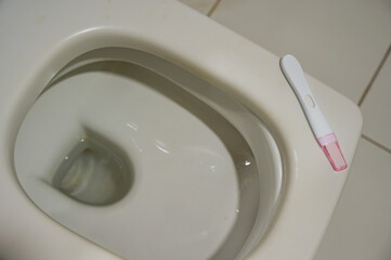 Pregnancy test on the toilet. 
