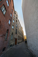 narrow european alleyway with brick and stone buildings.