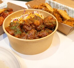 Korean deep dried chicken on white rice with soy garlic sauce.