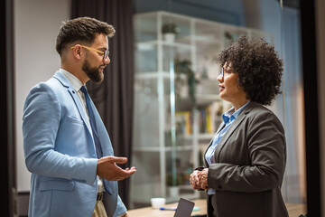 businessman with mature african american woman executive in office