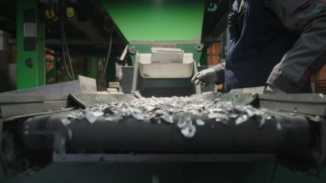 Men workers of garbage processing plant sort garbage. Male workers sort and recycle scrap metal. Plastic, polymer household waste is transported on conveyor belt in factory. Ecology of planet. Man