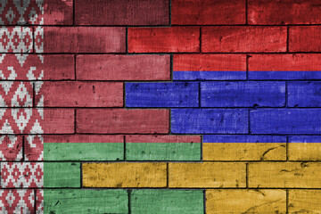 Fototapeta premium colourful painted big national flag of belarus and flag of armenia on a massive old brick wall background. concept