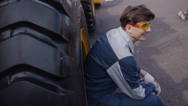 Truck driver coal mine in uniform with helmet relax and looking to side. Concept man industrial hard work portrait.