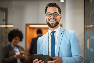 Portrait of a well-dressed caucasian businessman stand with clipboard