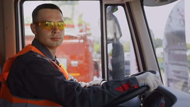 Man driver of truck or mining lorry at construction site, Portrait Industry worker.