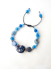 Blue stones kyanite aquamarine apatite beaded bracelet close up at white background isolated....