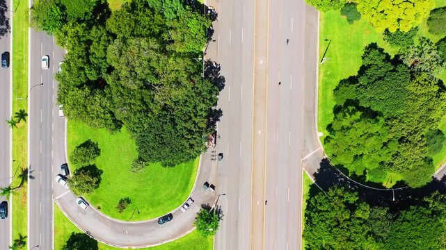 People walking and cycling in Bra&iacute;lia's Eix&atilde;o on a Sunday, when the avenue is free of cars.