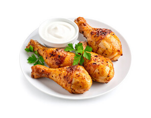 Grilled chicken drumsticks served on a white plate with dipping sauce