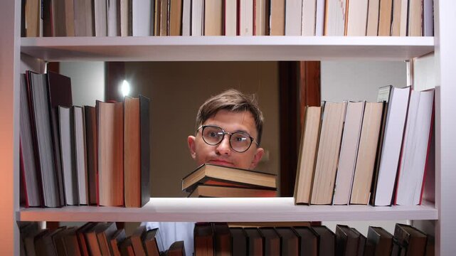 Student searching for book hiding behind bookshelf in library