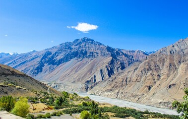 Fototapeta premium Majestic view of the Himalayan mountain range with snow capped peaks rising above the clouds, showcasing the raw beauty and serenity of nature. A breathtaking landscape capturing the vastness, silence