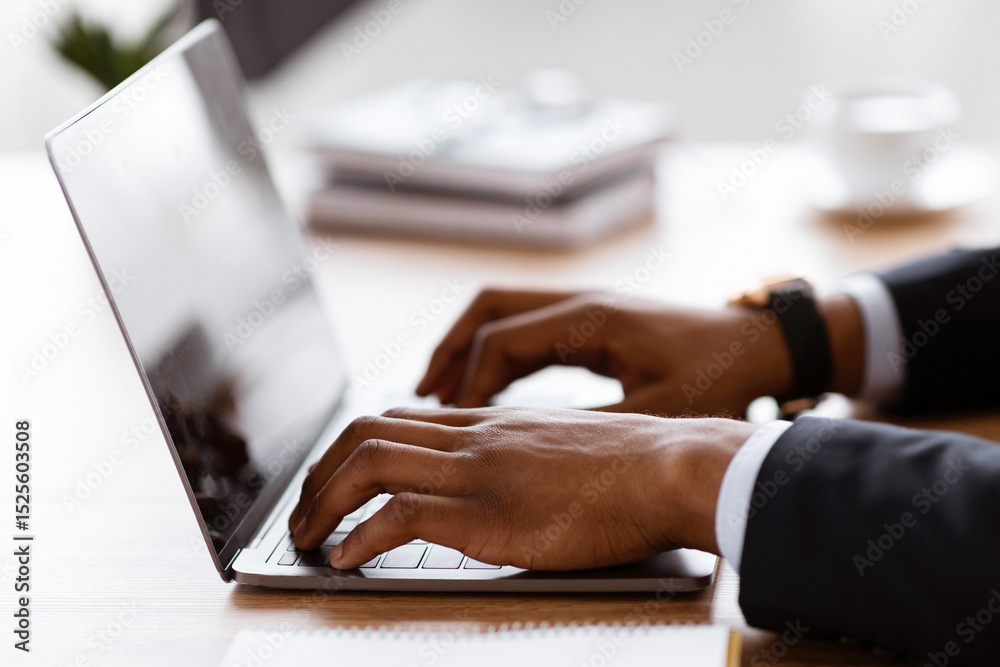 Poster Side view of unrecognizable black manager typing on modern laptop, sending emails or working on business project, office interior, cropped. African american businessman hands on keyboard, closeup