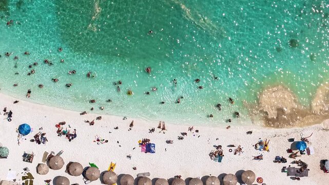 greece thassos marble beach 4k aerial footage time lapse people look like bacteria and plankton and mucilage in the sea approaching land over time marine pollution global warming