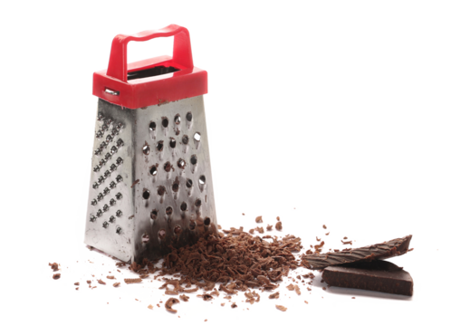 Kitchen grater and pile chopped, dark chocolate isolated on white background