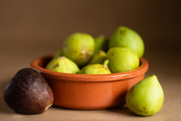 Close-Up of Fresh Figs in a Clay Bowl on Rustic Background