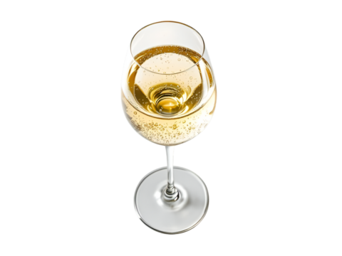 A top down view of a wine glass filled with sparkling white wine on a black background studio shot