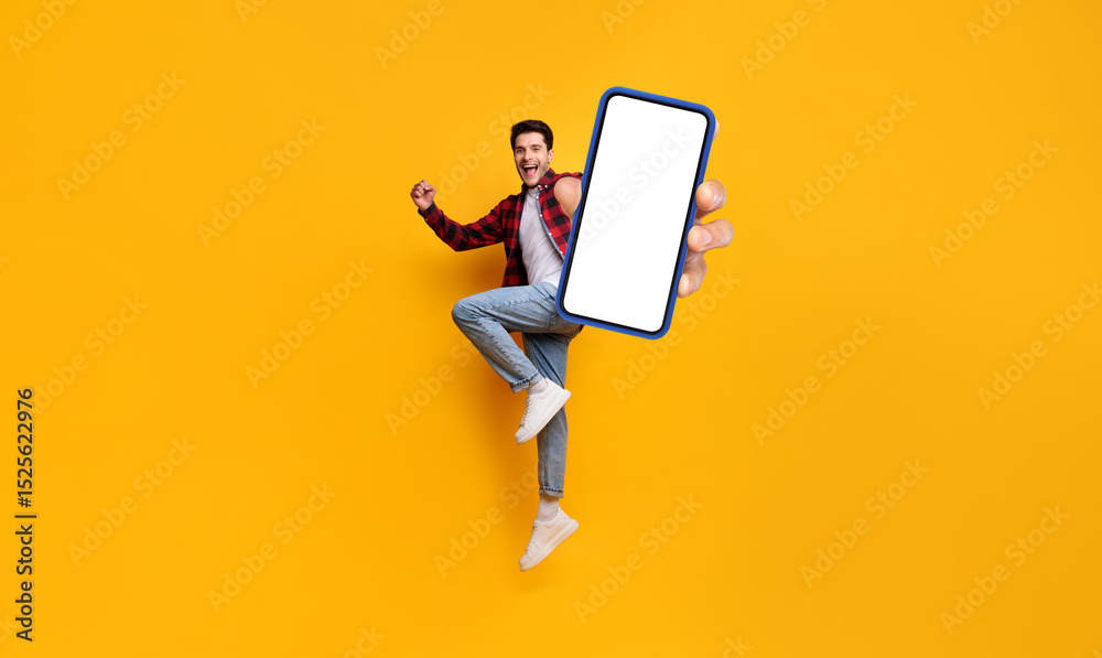 Leinwandbilder yes. full body length portrait of joyful man jumping up, making winner gesture with clenched fist an