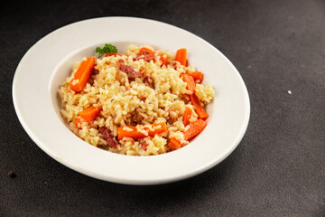 Rice meat and vegetables pilaf fresh delicious gourmet food background on the table rustic food top view copy space