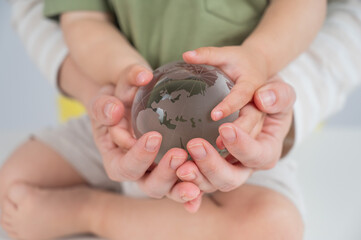 Mother and son holding a glass globe. 