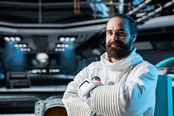 Portrait of astronaut in spacecraft running diagnostics to confirm suit integrity, preparing for...