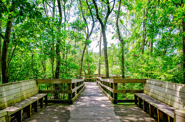Woooden benches and boardwalk at Magnolia Landing in Magnolia Springs Alabama