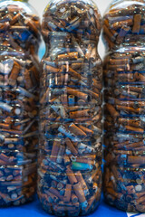 Plastic bottles showing cigarette butts collected from beach cleanup